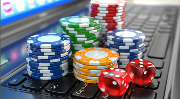 An image of casino chips on top of a computer keyboard